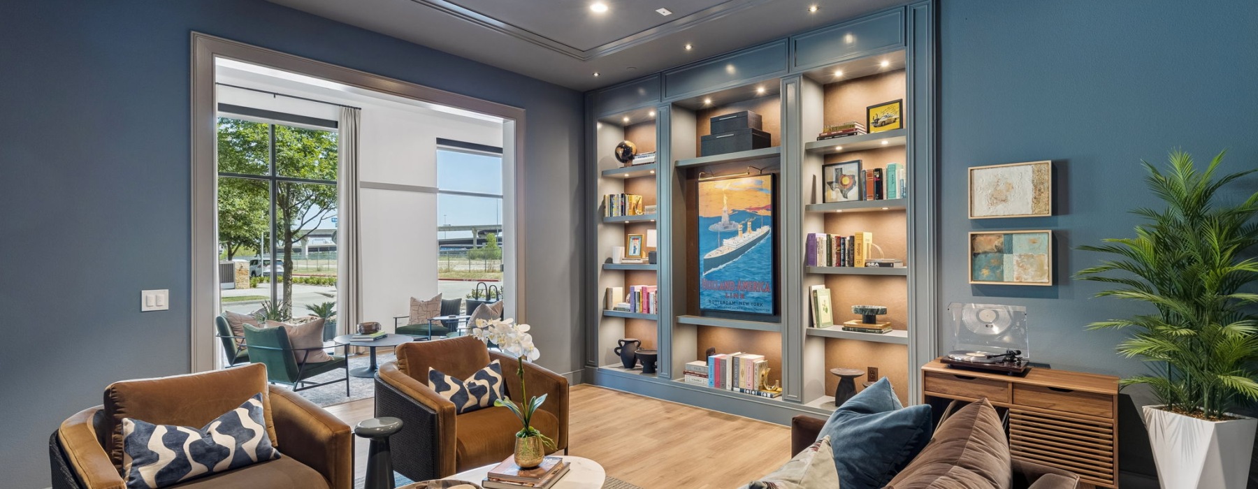 Library lounge with seating, book shelf, and record player