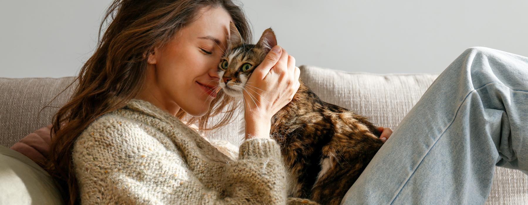 a woman lying on a couch with a cat